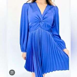 Blue boutique mini dress with pleated skirt and twist front v-neck. Size XS.